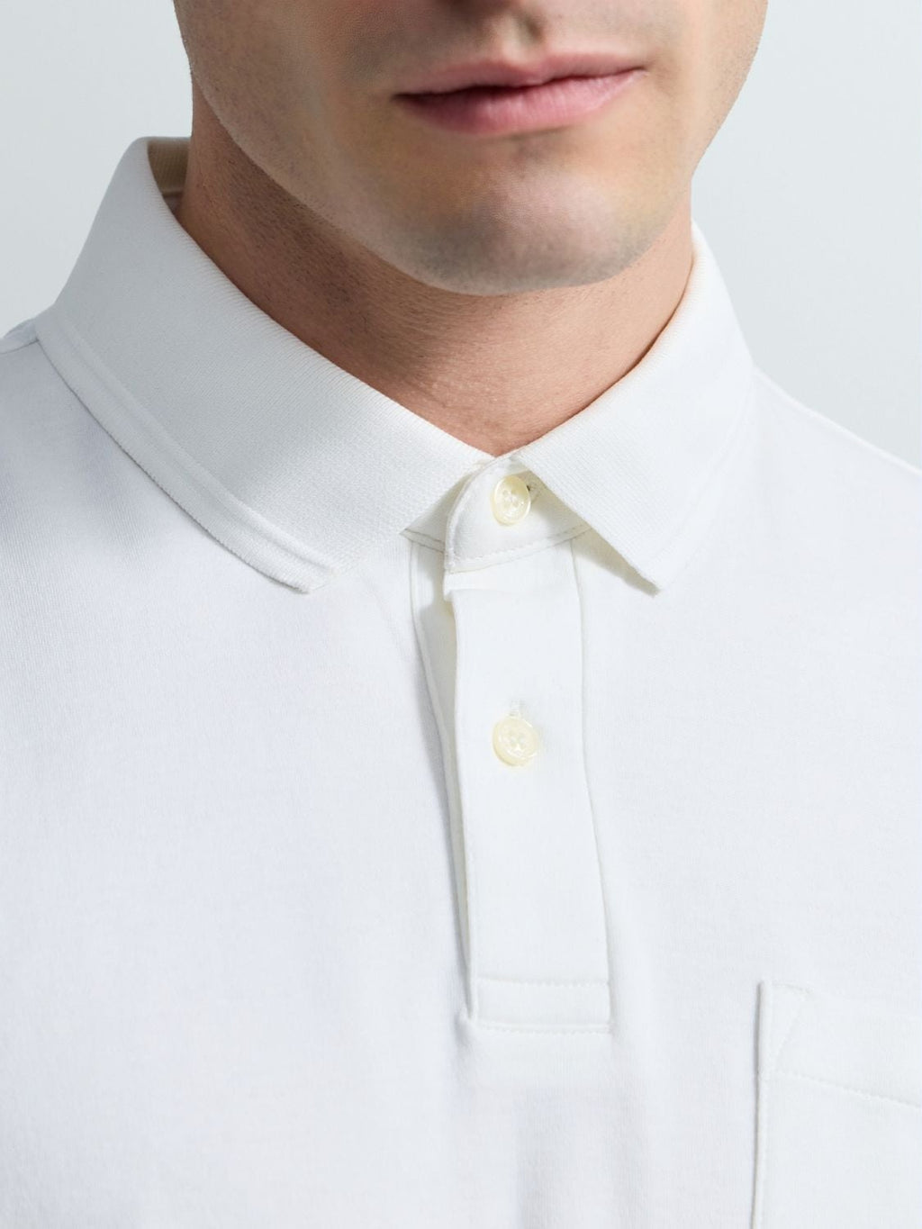 Polo in jersey con taschino e ricamo R